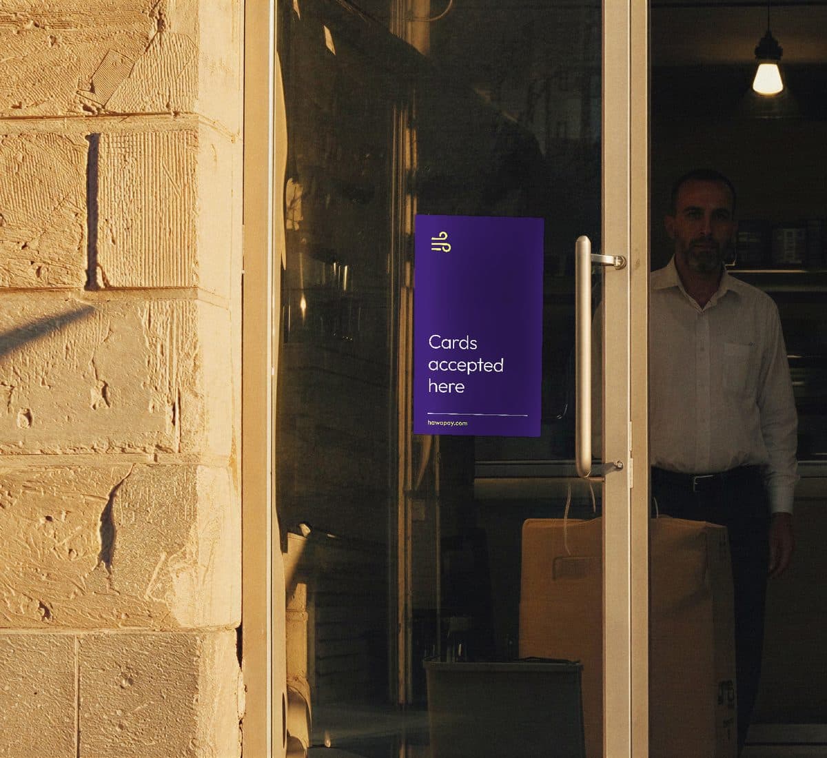 A shop door with the HawaPay decal in the glass, reading Cards accepted here